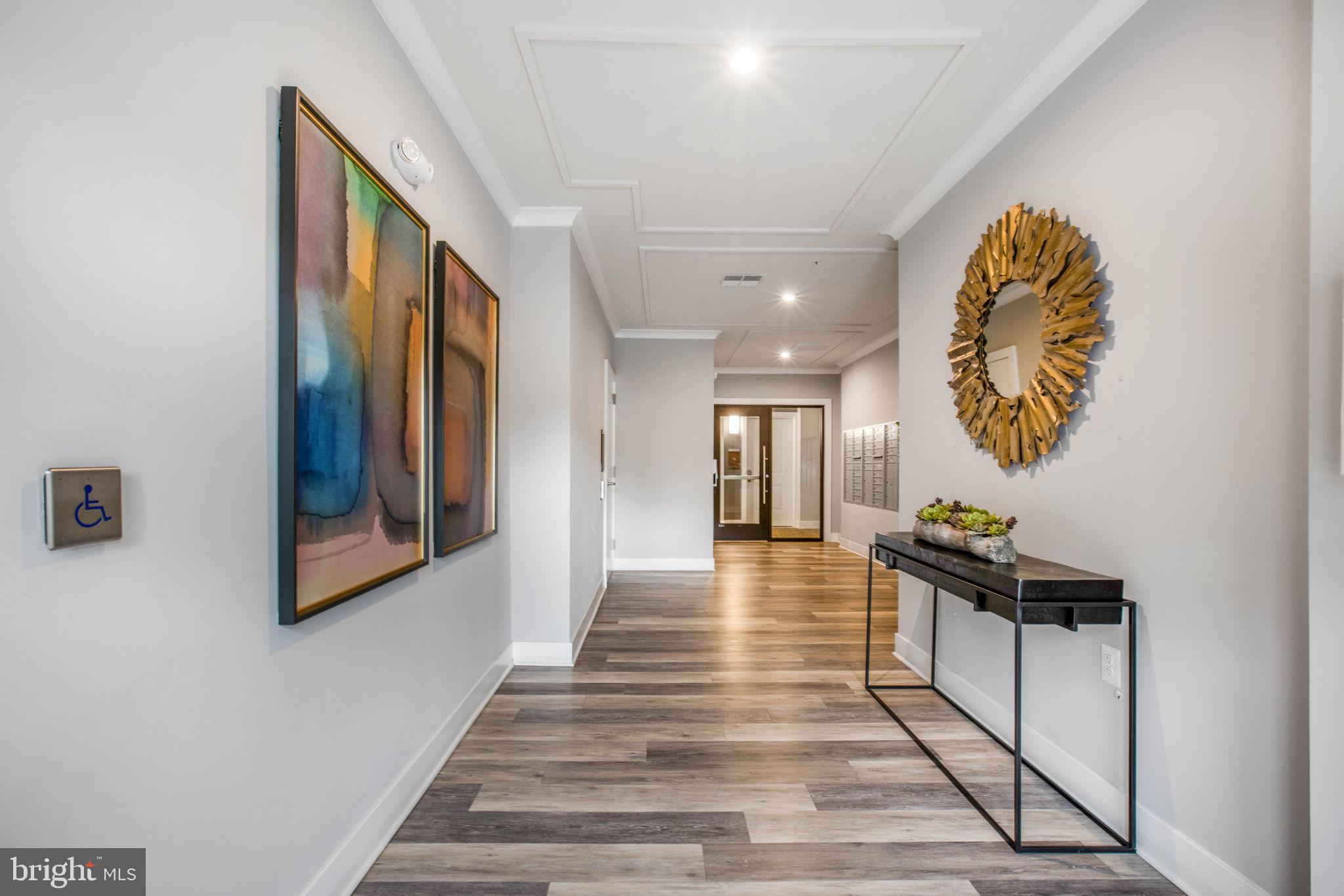 1669 Bandit Loop, Unit 107A Reston, VA 20190 - Photo 28 of 30 a living room with furniture and a wooden floor