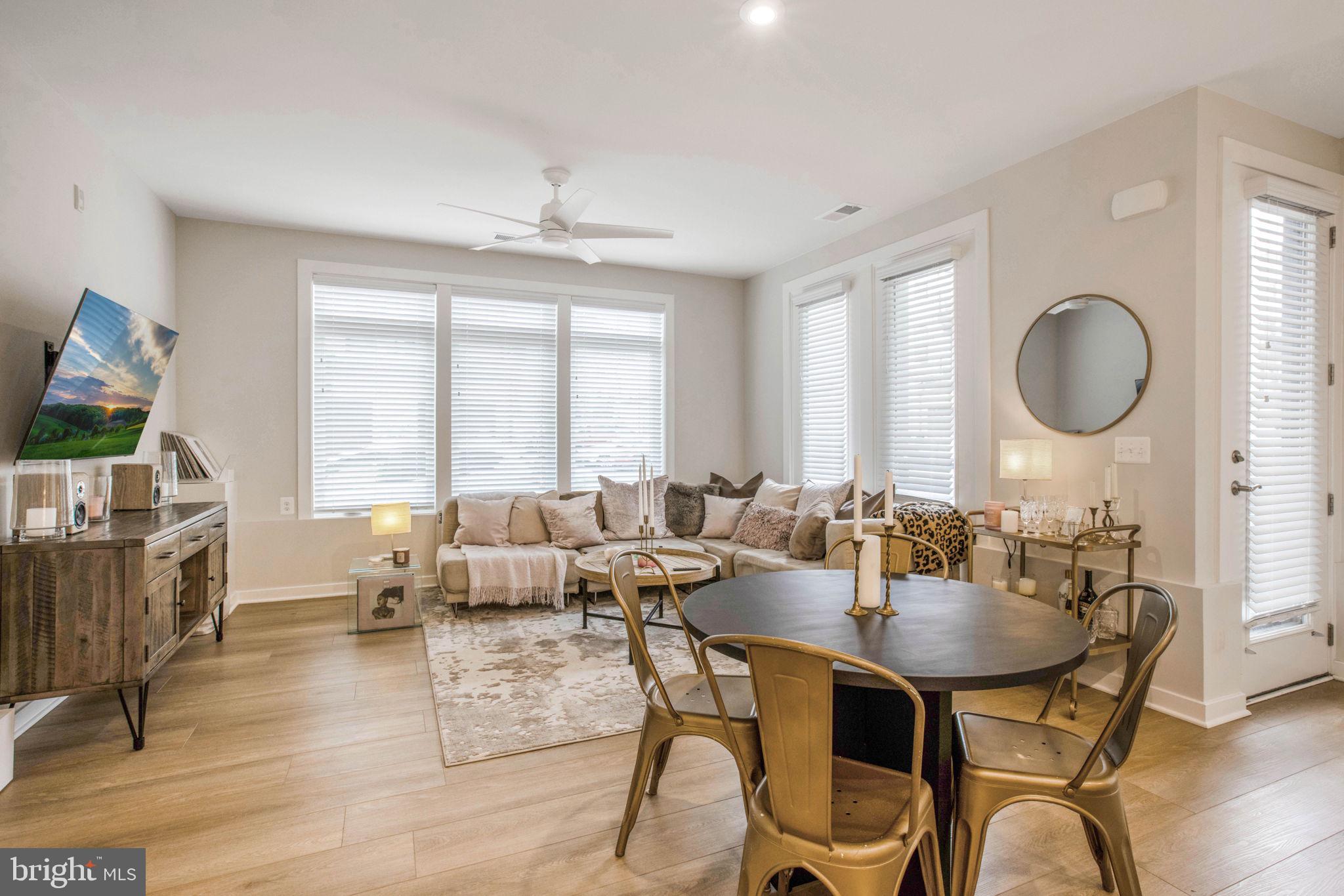 1669 Bandit Loop, Unit 107A Reston, VA 20190 - Photo 3 of 30 a living room with fireplace furniture and a large window