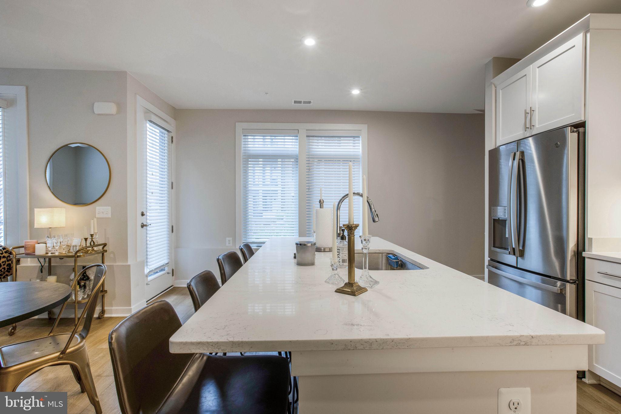 1669 Bandit Loop, Unit 107A Reston, VA 20190 - Photo 8 of 30 a kitchen with stainless steel appliances a sink and a refrigerator