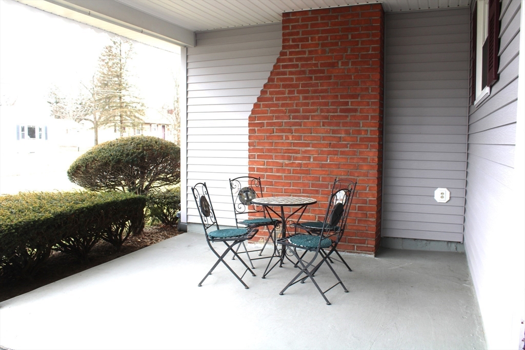24 Metzger Place Springfield, MA 01104 - Photo 31 of 35 a patio with table and chairs and potted plants