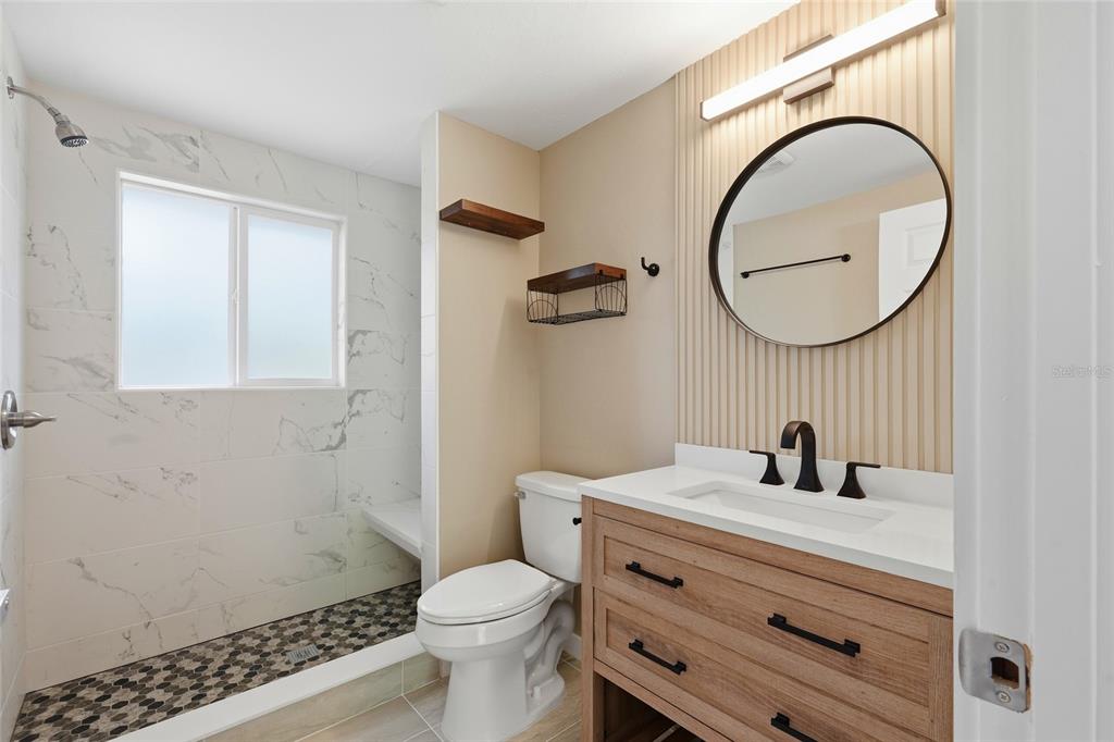 5984 Diana Road Venice, FL 34293 - Photo 23 of 36 a bathroom with a sink a toilet and a mirror