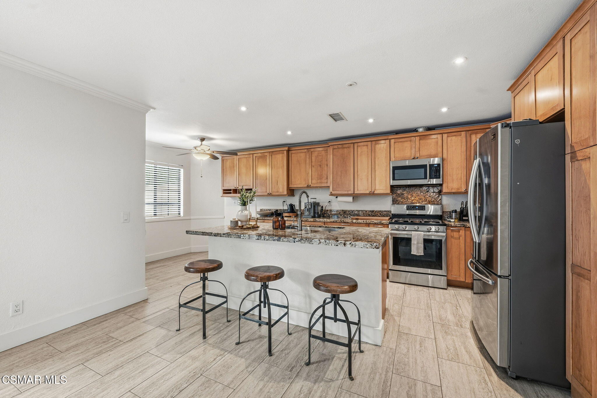 847 Links View Drive Simi Valley, CA 93065 - Photo 17 of 45 a kitchen with stainless steel appliances a refrigerator a stove a sink dishwasher with a dining table and chairs