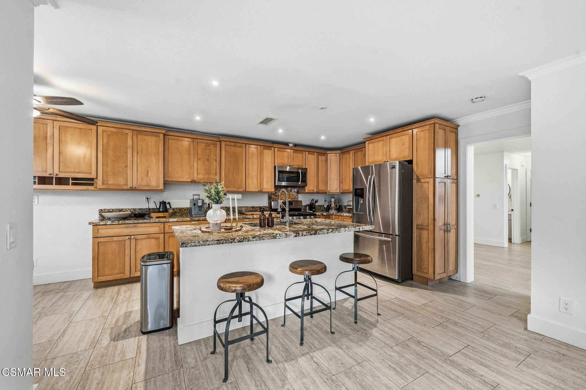 847 Links View Drive Simi Valley, CA 93065 - Photo 4 of 45 a kitchen with a refrigerator a stove top oven a sink dishwasher and wooden cabinets with wooden floor