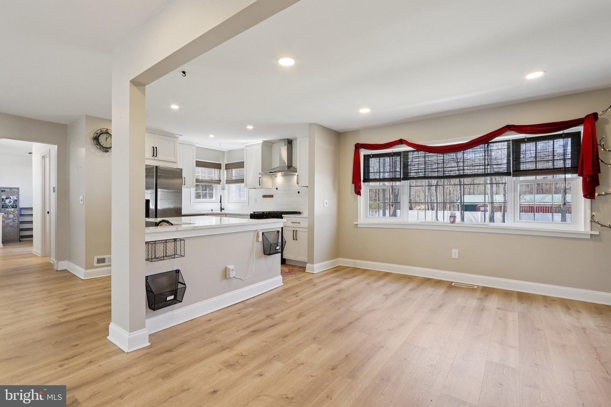 351 Merrick Road Robbinsville, NJ 08691 - Photo 18 of 69 a large kitchen with kitchen island a stove a refrigerator wooden floor and a view of living room