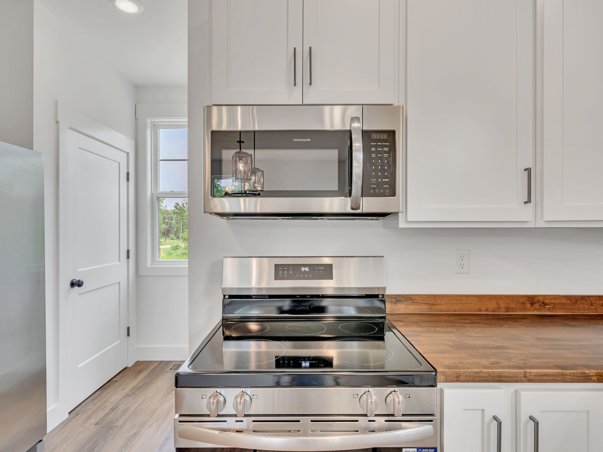 5800 Sanders Road Lyles, TN 37098 - Photo 13 of 28 a stove top oven sitting inside of a kitchen