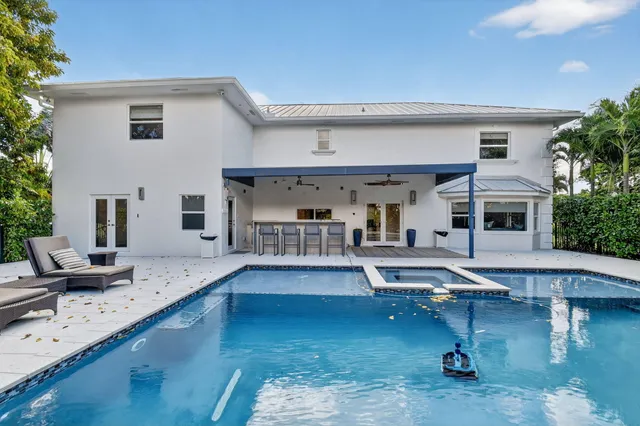 a view of a swimming pool with outdoor seating