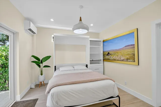 a bedroom with a bed and a painting on the wall