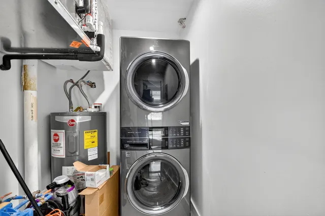 a utility room with dryer washer and a view of living room