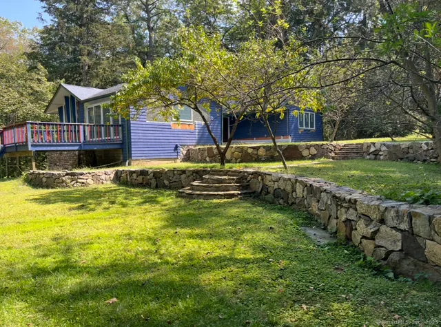 a swimming pool with outdoor seating and yard