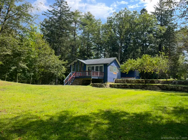 a view of a house with swimming pool and a yard