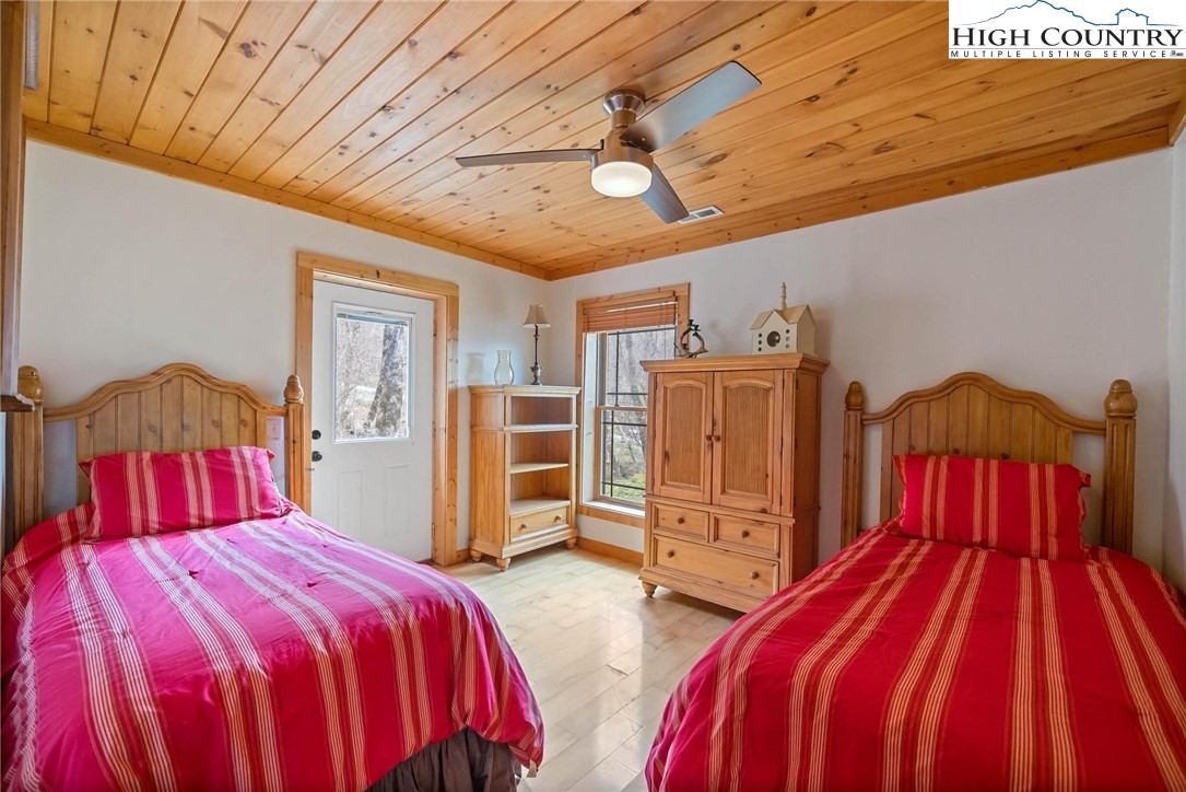 140 Spruce Hollow Road Beech Mountain, NC 28604 - Photo 30 of 50 a bedroom with bed and wooden floor