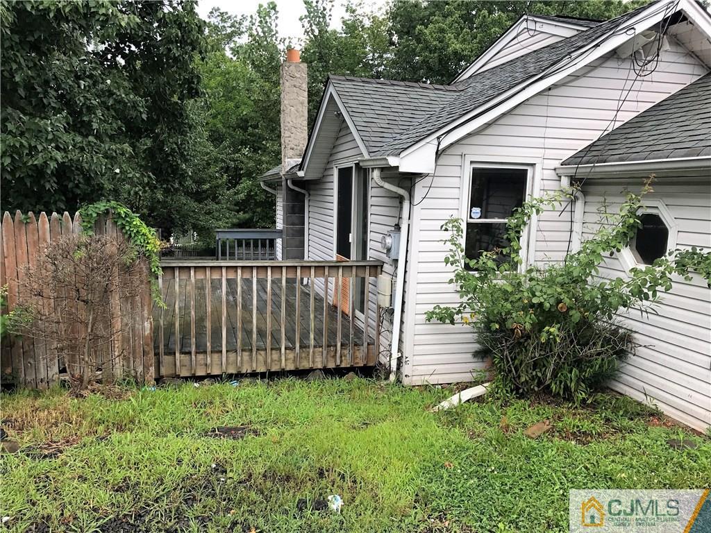 403 Matawan Road Old Bridge, NJ 08879 - Photo 4 of 11 a view of a small house with wooden fence
