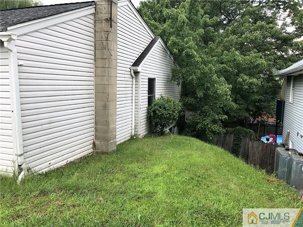 403 Matawan Road Old Bridge, NJ 08879 - Photo 5 of 11 a view of a backyard with plants and a patio