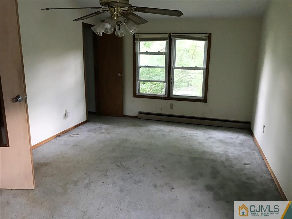 403 Matawan Road Old Bridge, NJ 08879 - Photo 7 of 11 a view of an empty room with a window