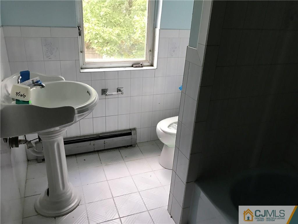 403 Matawan Road Old Bridge, NJ 08879 - Photo 8 of 11 a bathroom with a sink toilet and window