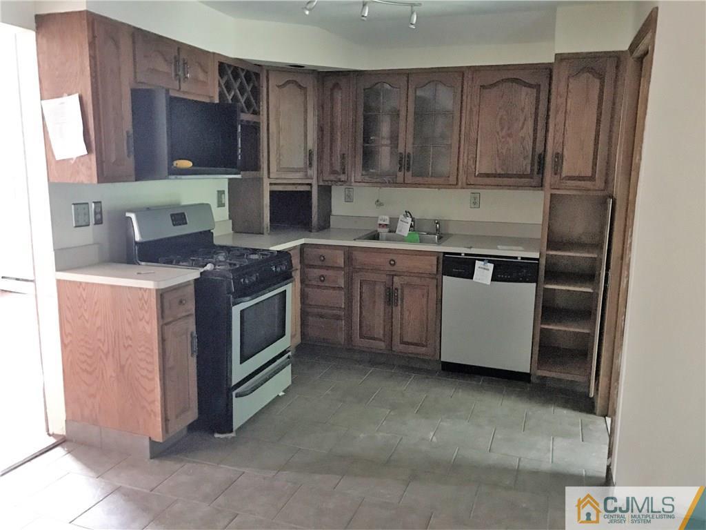 403 Matawan Road Old Bridge, NJ 08879 - Photo 10 of 11 a kitchen with stainless steel appliances granite countertop a stove a sink dishwasher and a refrigerator