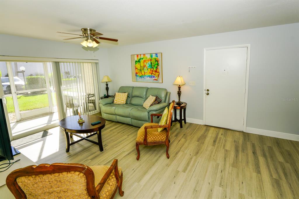 3251 South Beneva Road, Unit 101 Sarasota, FL 34232 - Photo 13 of 22 a living room with furniture and wooden floor