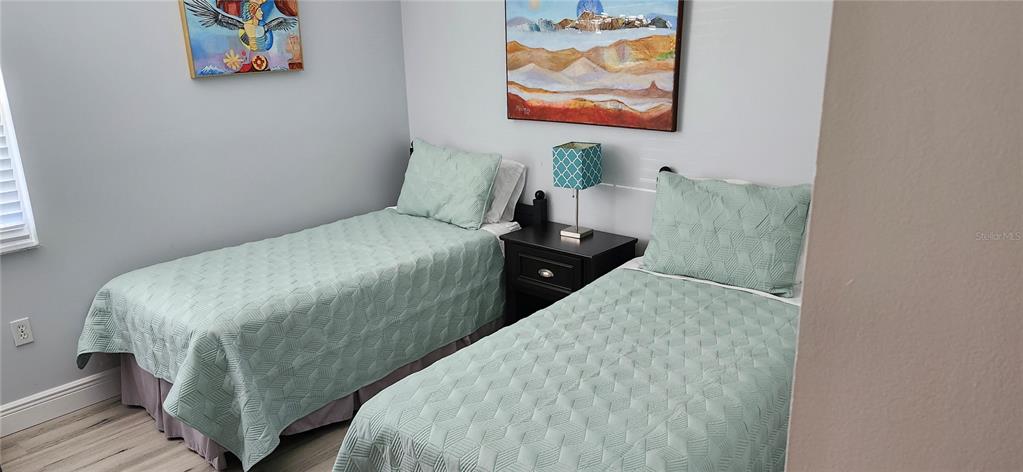 3251 South Beneva Road, Unit 101 Sarasota, FL 34232 - Photo 17 of 22 a bedroom with bed and wall painting