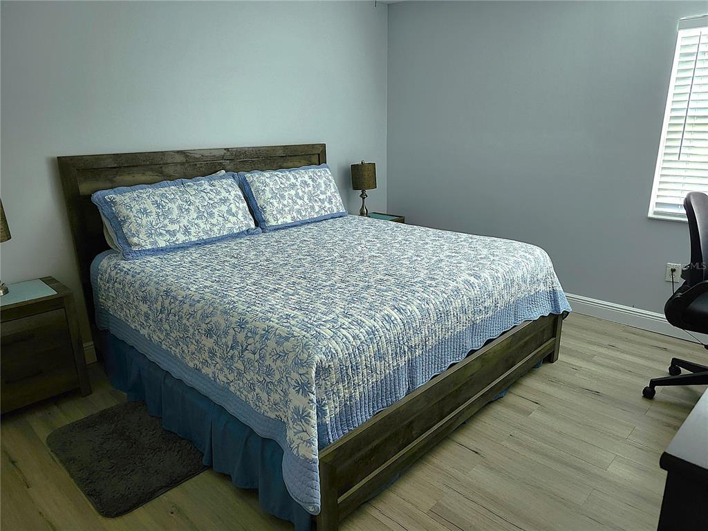 3251 South Beneva Road, Unit 101 Sarasota, FL 34232 - Photo 19 of 22 a bed sitting in a bedroom next to a window