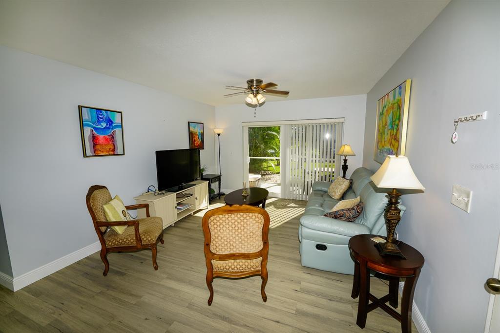 3251 South Beneva Road, Unit 101 Sarasota, FL 34232 - Photo 7 of 22 a living room with furniture and a flat screen tv