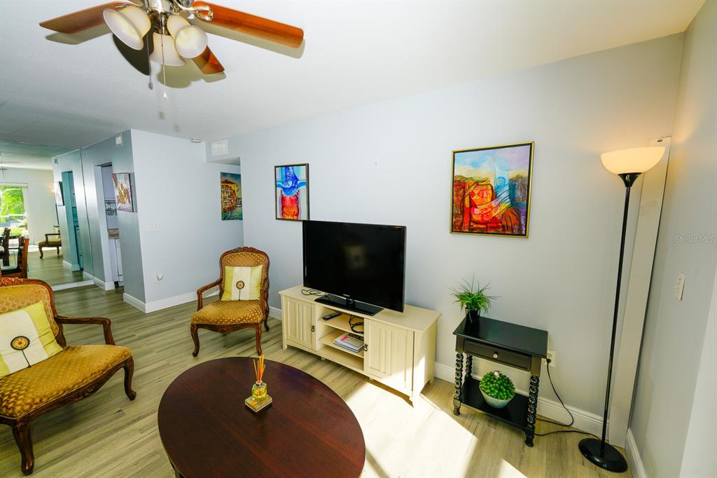 3251 South Beneva Road, Unit 101 Sarasota, FL 34232 - Photo 8 of 22 a living room with furniture and a flat screen tv
