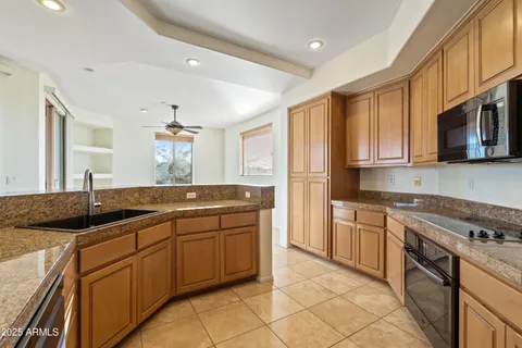 a kitchen with stainless steel appliances granite countertop a sink and cabinets