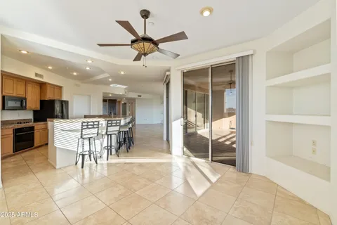 a view of a kitchen with dining area a sink and a refrigerator