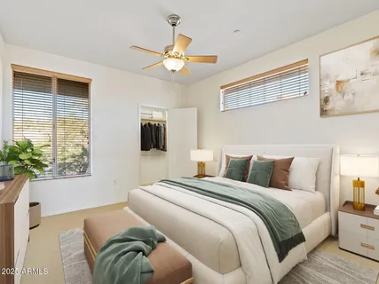 a bedroom with a bed and a chandelier