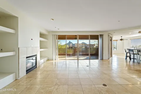 a view of an empty room with a fireplace and a large window