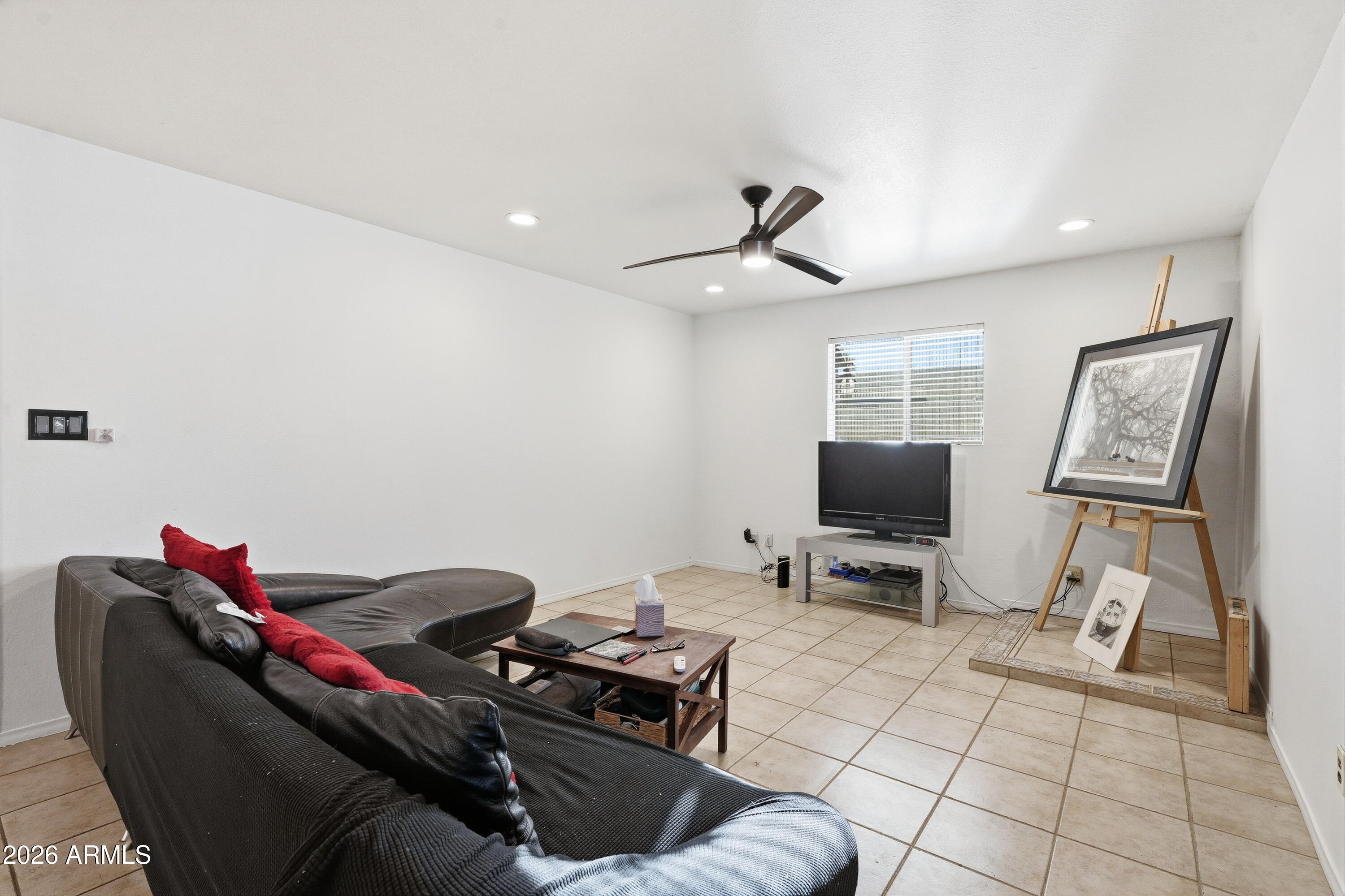 3830 East Shangri La Road Phoenix, AZ 85028 - Photo 11 of 53 a living room with furniture a flat screen tv and a window
