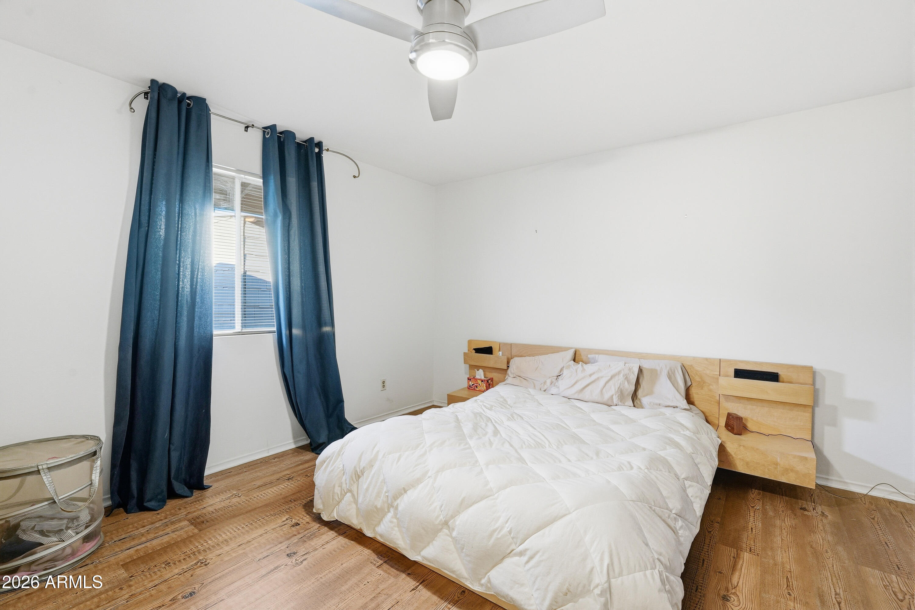 3830 East Shangri La Road Phoenix, AZ 85028 - Photo 25 of 53 a bedroom with a bed and wooden floor