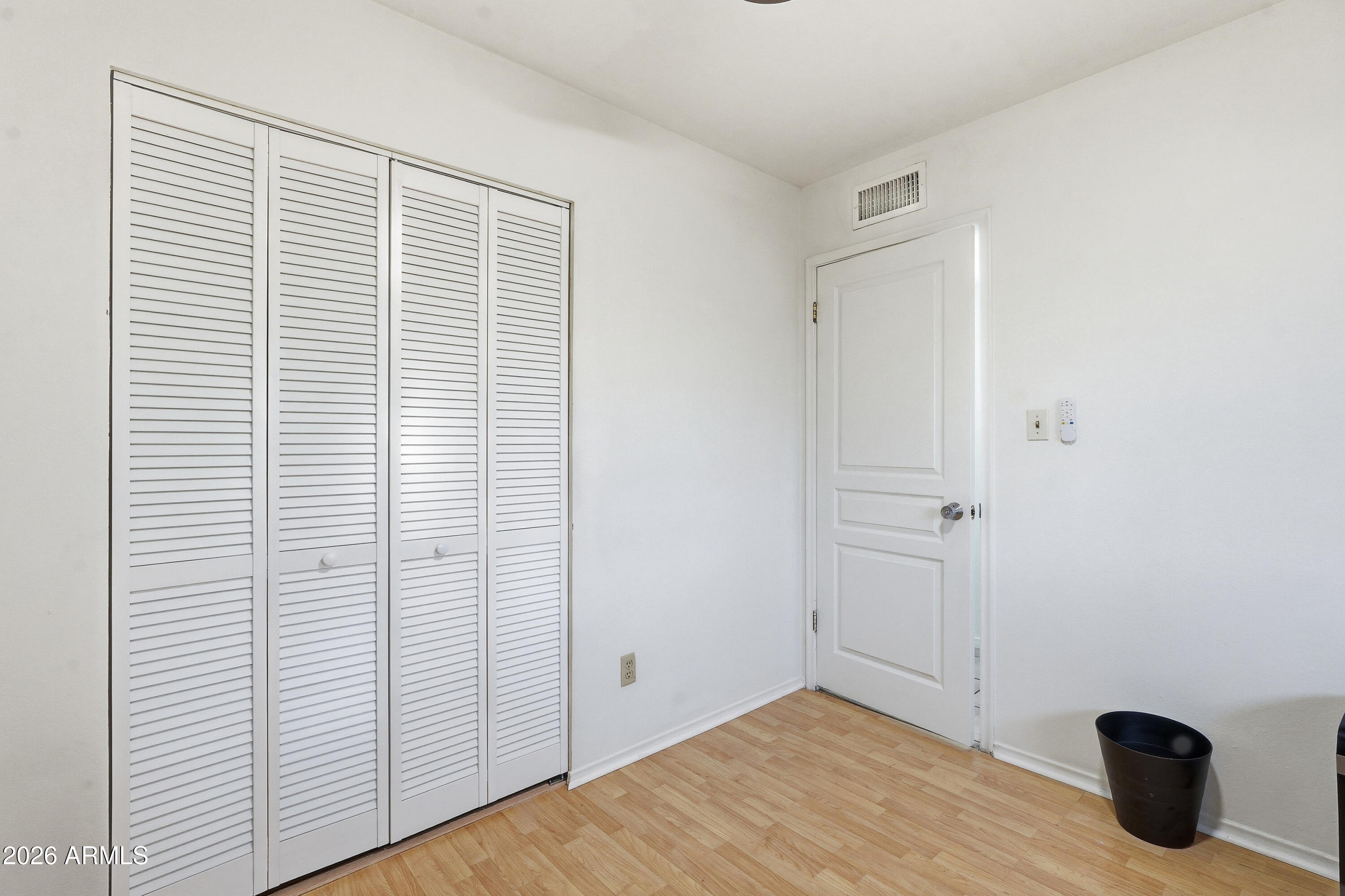 3830 East Shangri La Road Phoenix, AZ 85028 - Photo 35 of 53 a view of an empty room with wooden floor and closet