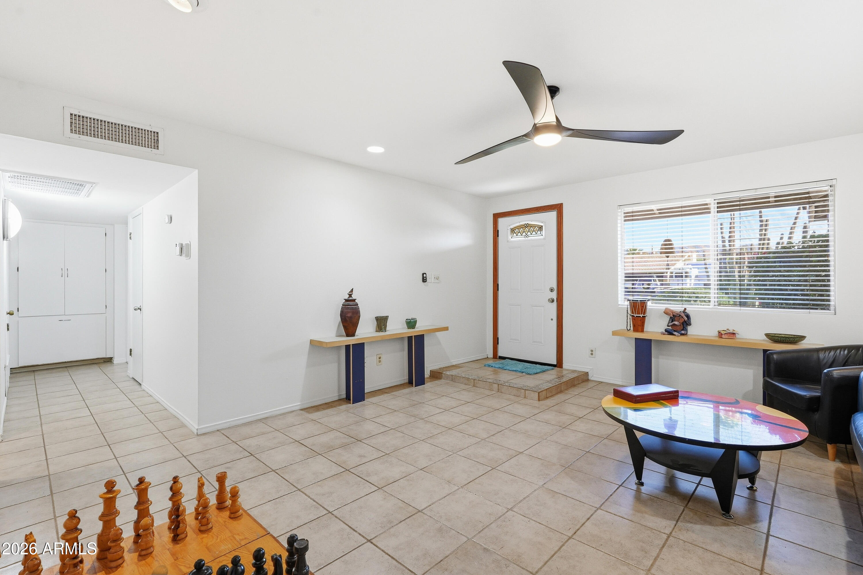 3830 East Shangri La Road Phoenix, AZ 85028 - Photo 9 of 53 a living room with a table chairs and a refrigerator