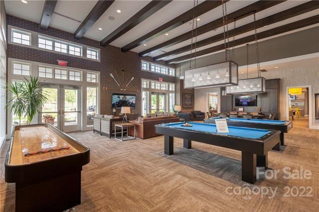 192 Flat Rock Drive Denver, NC 28037 - Photo 23 of 32 a living room with furniture a pool table and a large window
