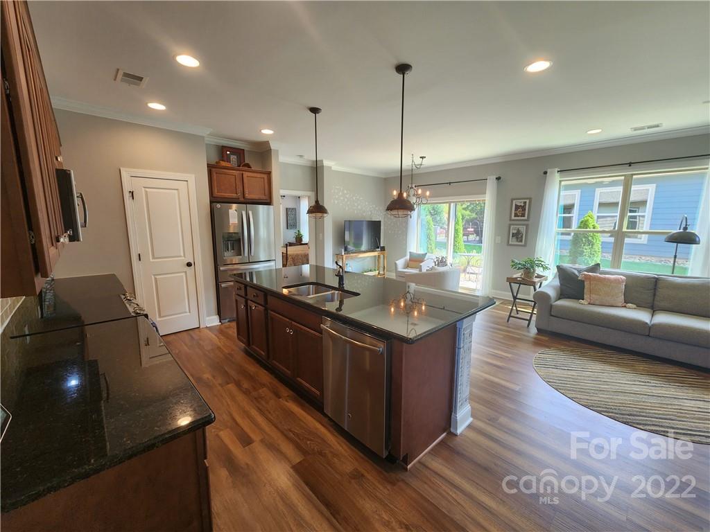 192 Flat Rock Drive Denver, NC 28037 - Photo 6 of 32 a kitchen with stainless steel appliances granite countertop a sink counter space and living room view