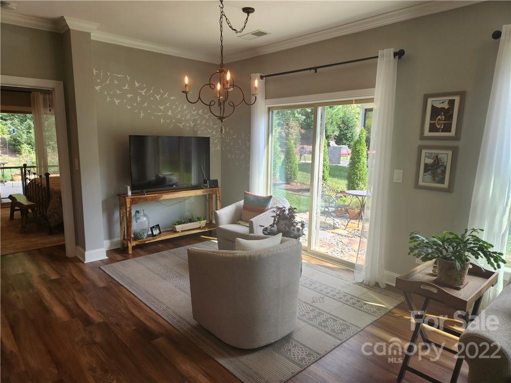 192 Flat Rock Drive Denver, NC 28037 - Photo 8 of 32 a living room with furniture a flat screen tv and a large window
