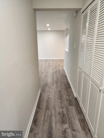 a view of a hallway with wooden floor