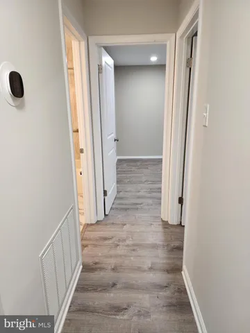 a view of a hallway with wooden floor