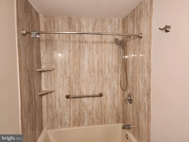 a bathroom with a shower and a tub