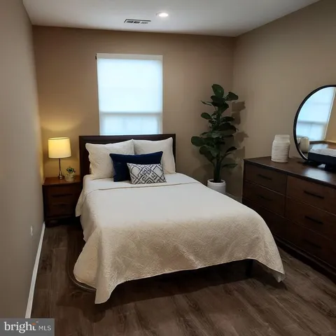 a bedroom with a bed and a potted plant
