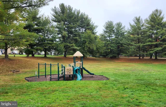 a view of outdoor space with playground and green space