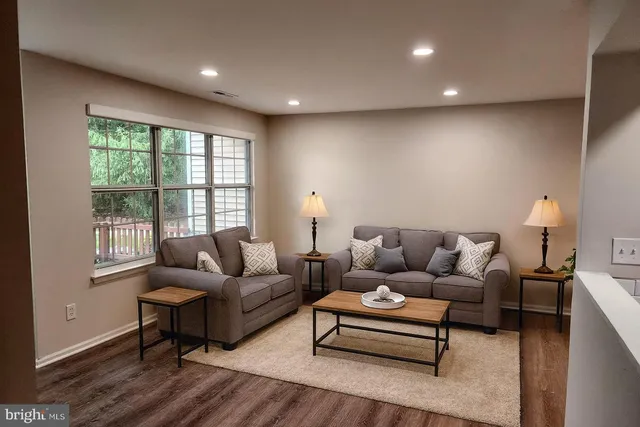 a living room with furniture and a lamp