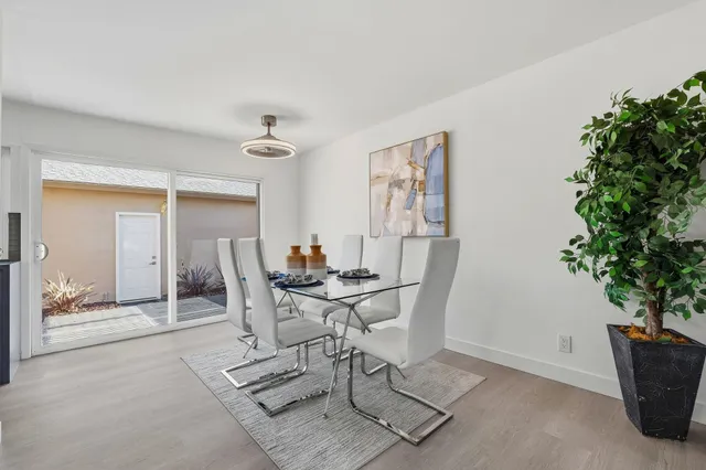 a view of a dining room with furniture and window