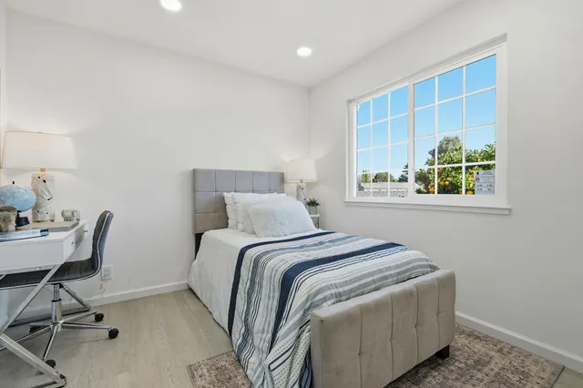 a bedroom with a bed and a desk