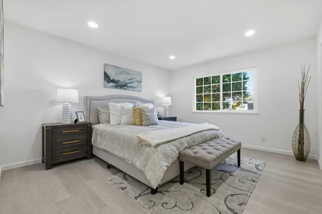 a bedroom with a bed and a table