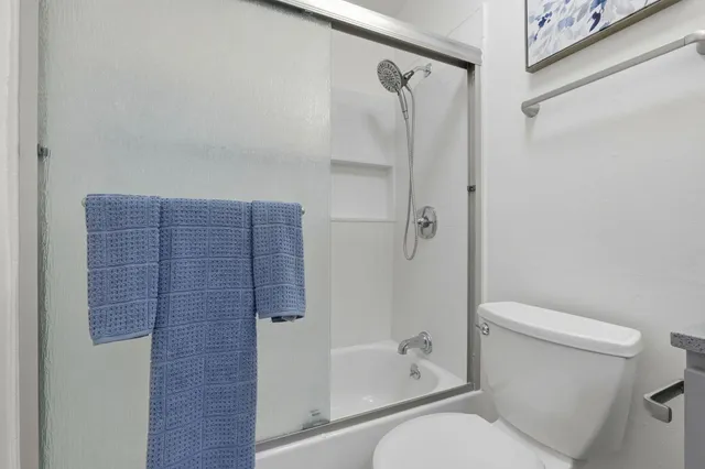 a bathroom with a toilet and a bathtub