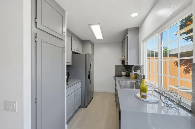 a kitchen with stainless steel appliances a refrigerator and a stove