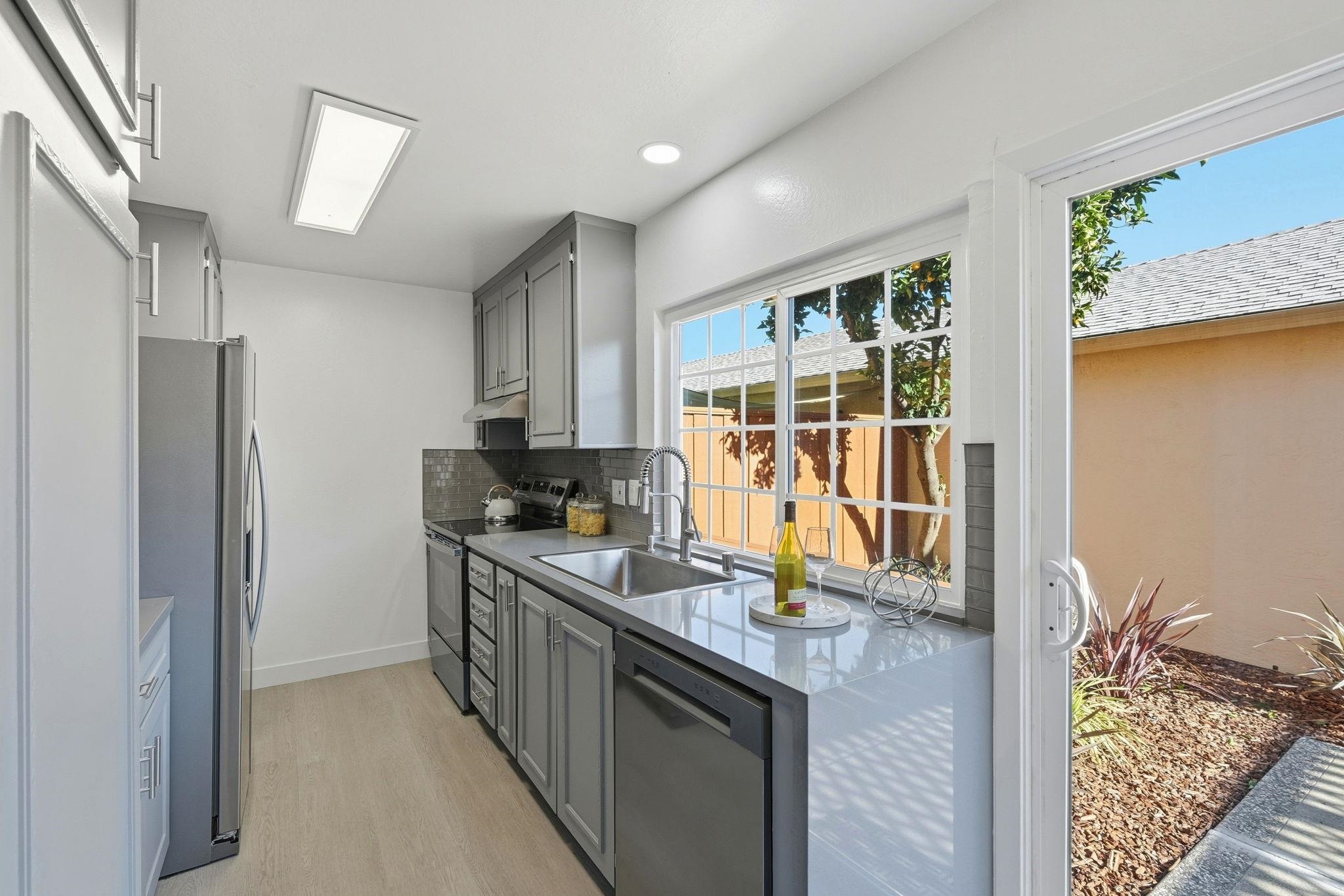 4290 Solar Circle Union City, CA 94587 - Photo 10 of 35 a kitchen with granite countertop a sink stove and refrigerator