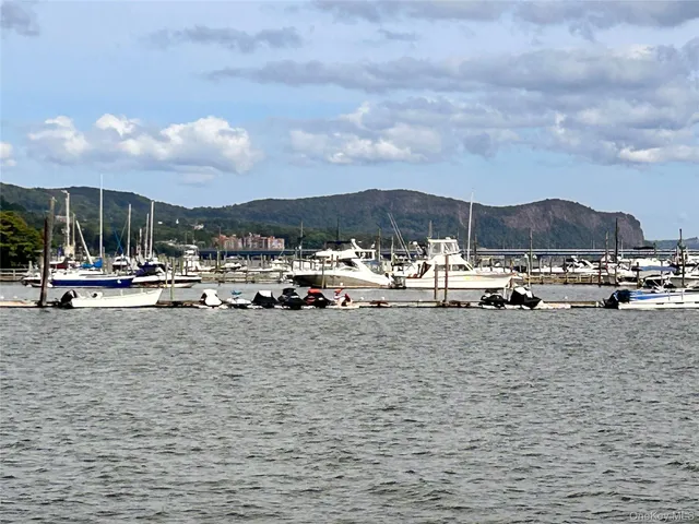 a view of backyard with table and chairs and wooden fence