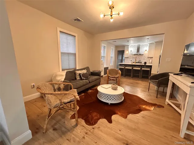 a living room with furniture and a dining table